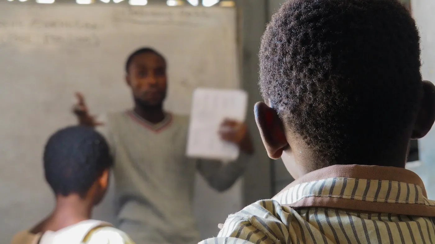 A teacher instructing students in a classroom