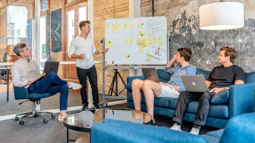 Team planning a business workflow at a whiteboard